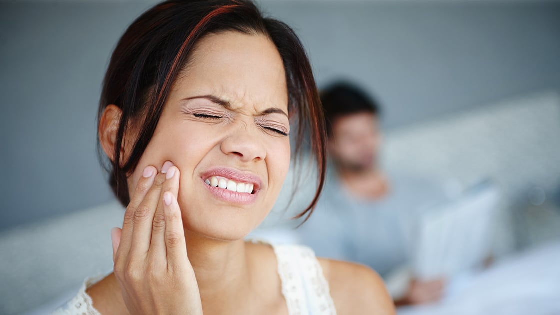 Woman holding jaw